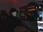 Person in Black Hoodie Hacking a Computer System